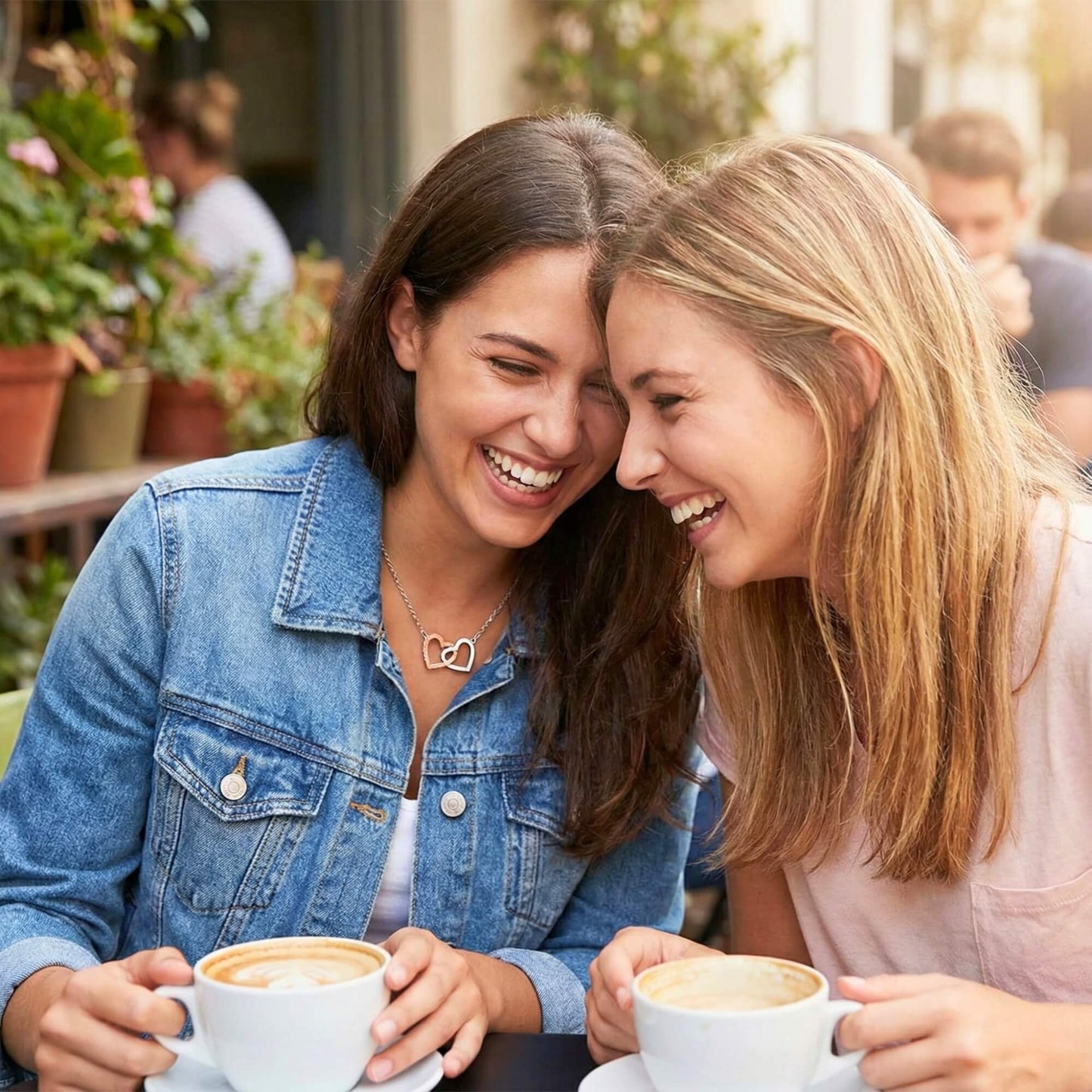 Close-up of two besties with heads together sharing a sweet moment, perfect for long-distance friendship gifts.