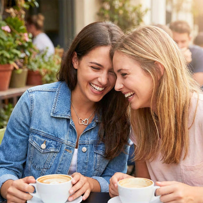 Close-up of two besties with heads together sharing a sweet moment, perfect for long-distance friendship gifts.