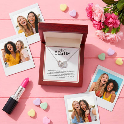Creative flat lay of the Bestie necklace gift set with Polaroids, lipstick, and heart confetti for Valentine's Day.