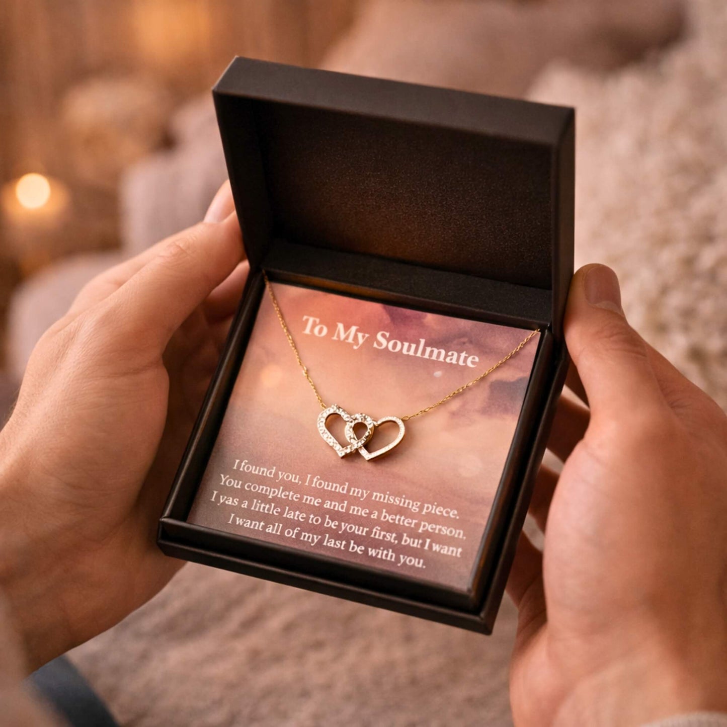 Macro close-up detail of the sparkling cubic zirconia interlocking hearts pendant resting on the To My Soulmate message card.